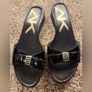 Anne Klein Black Patent Slide Mules with Bow and Logo Accent